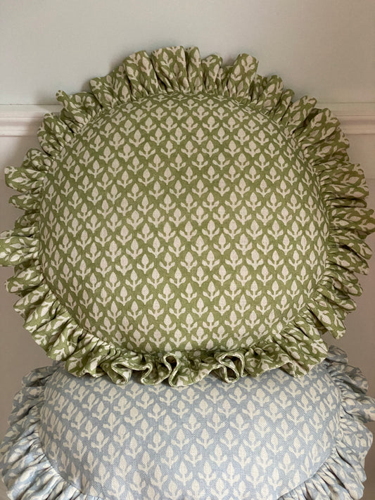 A LIMITED EDITION FRILLY CIRCULAR CUSHION IN BUD LEAF A FABRIC DESIGN FROM THE ANDREW MARTIN GARDEN PATH COLLECTION